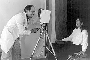 man taking an aura photo of a woman