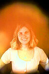 smiling woman with an orange aura
